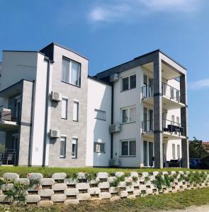 an apartment building with a row of seats in front at Classy Villány in Villány