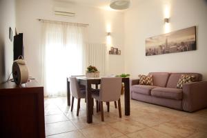 a living room with a table and a couch at Residenza Le Chianche in Latiano