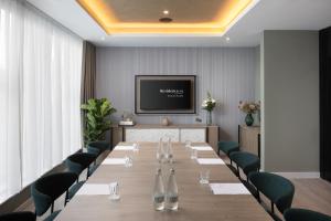 a conference room with a long table and chairs at Residence Inn by Marriott Manchester Piccadilly in Manchester