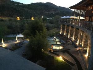 a view of a pool at a resort at night at Casa Maside Orense in Maside