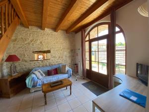 a living room with a couch and a table at Domaine Les Granges in Saint-Jean-dʼAngély +35 photos