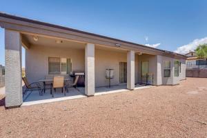 a house with a patio with a table and chairs at Beautiful Bullhead City Home Rental with Yard! in Bullhead City