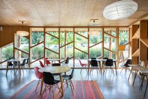 a room with tables and chairs and large windows at CityKamp Strasbourg in Strasbourg