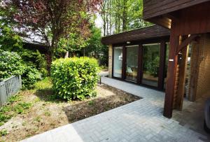 a patio of a house with glass windows and a building at Ferienhaus mit Sauna in Molbergen