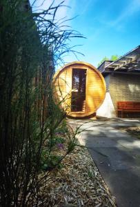 a wooden pod on the side of a house at Ferienhaus mit Sauna für romantische Zweisamkeit in Molbergen