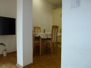 a dining room with a table and chairs and a television at Apartment Jalps 2 in Bohinj