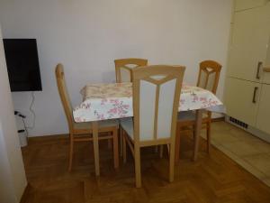 a table and chairs in a room with a kitchen at Apartment Jalps 2 in Bohinj