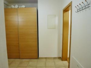 a hallway with a closet and a wooden door at Apartment Jalps 2 in Bohinj