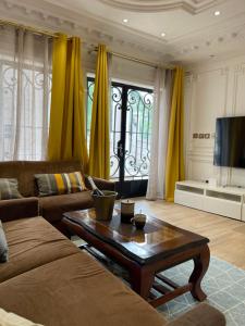 a living room with a couch and a coffee table at EVE HOME in Yaoundé