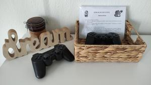 a basket with two video game controllers and a box at Hygge Home at Trikala in Tríkala
