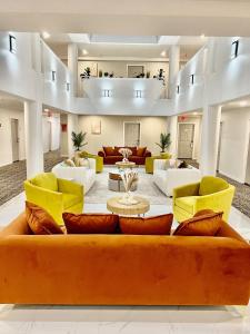 a large living room with a couch and chairs at Hotel Aluxor SFO, Sapphire Boutique Collection in San Bruno