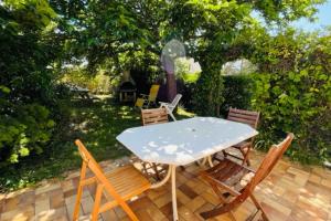 a table and chairs sitting on a patio at House with garden close to the sea in Sarzeau +4 photos