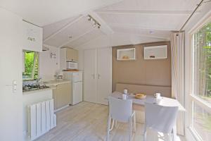 a kitchen with a table and chairs in a room at CityKamp Strasbourg in Strasbourg +27 photos