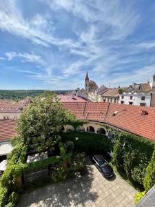 a car parked in the courtyard of a building with roofs at Palác Daun - Studio Apartments in Znojmo