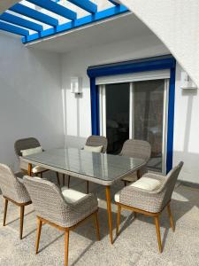 a table and chairs in a room with a blue ceiling at 4 bedroom twin house in Mountain View Ras El Hekma near the North Coast in Sīdī ‘Abd ar Raḩmān