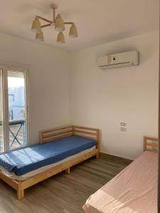 a bedroom with two beds and a window at 4 bedroom twin house in Mountain View Ras El Hekma near the North Coast in Sīdī ‘Abd ar Raḩmān