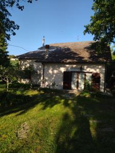 a white house with a large window in a yard at La Casa di Cesarina in Celle sul Rigo