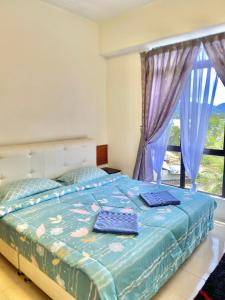 Ein Bett oder Betten in einem Zimmer der Unterkunft Marina Cove, Lumut