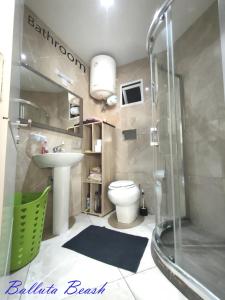 a bathroom with a shower and a toilet and a sink at Holiday - Malta Balluta Beach in Sliema