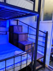 a bunk bed with blue lights on top at Holiday - Malta Balluta Beach in Sliema