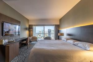 a hotel room with a large bed and a large window at Enjoy Punta del Este in Punta del Este +37 photos