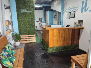 a bar in a room with a counter at La Hacienda Rooms & Food in Jacó