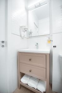 a bathroom with a sink and a mirror at Studio Vladut in Saturn +18 photos