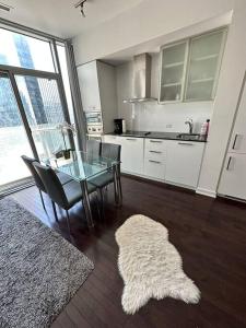 a kitchen with a glass table and a dining room at Downtown Toronto Luxury Condo in Toronto