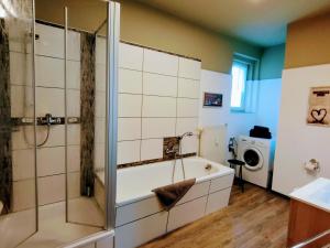 a bathroom with a shower and a bath tub at Ferienwohnungen Schneider in Görlitz +20 photos
