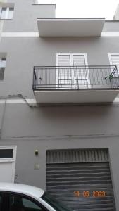 un edificio con puerta de garaje y balcón en polahouse, en Sciacca