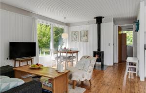 ein Wohnzimmer mit einem Tisch und einem Kamin in der Unterkunft Awesome Home In Grevinge With Wifi in Grevinge