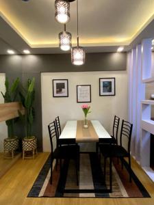 a dining room with a table and chairs at Cozy Condo in Pasig City- Bali Oasis 2 in Manila