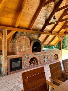 a large outdoor kitchen with a brick oven at Midom in Małdyty