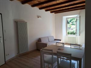 a living room with a table and a couch at CASA n 61 in Dervio