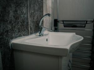 a bathroom sink with a faucet next to a staircase at New Village Home, Near to Beaches-Natural Zone in Ortaca