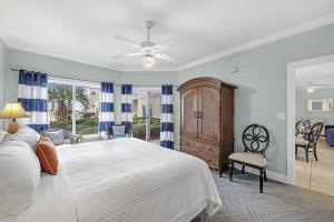 a bedroom with a large white bed and a window at Palm Beach Resort 15B in Gulf Shores