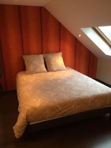 a bedroom with a large bed with a window at Chez Matthieu in Lannemezan