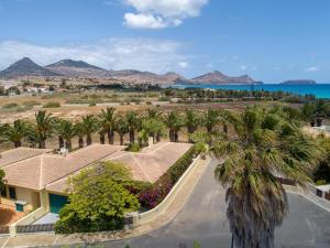 an aerial view of a resort with palm trees and the ocean at Oceano Azul in Porto Santo
