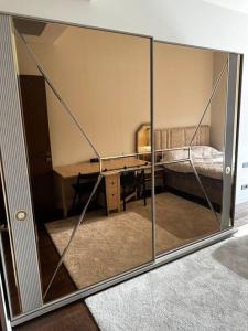 a room with a glass wall with a bed and a desk at Skyland for luxury people 1+1 in Istanbul