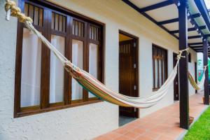 a hammock hanging outside of a house at Casa Tesoro Selva in Tarapoto