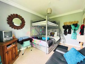 a bedroom with a bunk bed with a mirror at Redcastle Chateau by the Sea Sleeps 6!! in Red Castle
