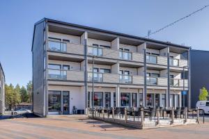 an apartment building with chairs in front of it at Starvillas B 202 Sisältää loppusiivouksen in Kalajoki +28 photos