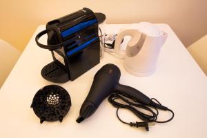 a white counter top with a hair dryer a pen and a hair dryer at Ostria Caldera Studios in Oia