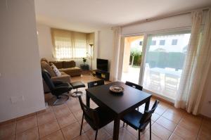 a living room with a table and chairs at Golive Bahia in Cambrils