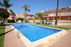 a swimming pool in front of a building at Golive Bahia in Cambrils