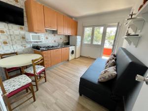 a kitchen with a couch and a table in a room at Apartamentos Sinás Playa in Raxó