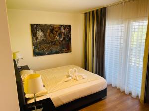 a bedroom with a bed with a towel on it at Hotel Swiss Bellevue in Kreuzlingen