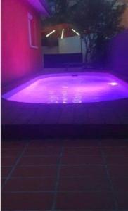 a purple swimming pool with pink lights in a house at Maison piscine à 15m du Stadium in Toulouse