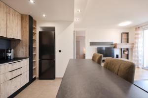 a kitchen with a black refrigerator and a table at Vista Zadar in Zadar