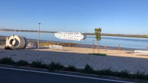 a boat in the water next to a body of water at APARTAMENTOS MESTRE in Ayamonte